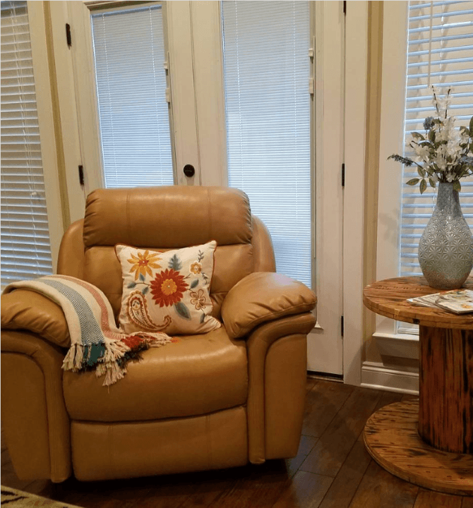 leather recliner with flower design pillow