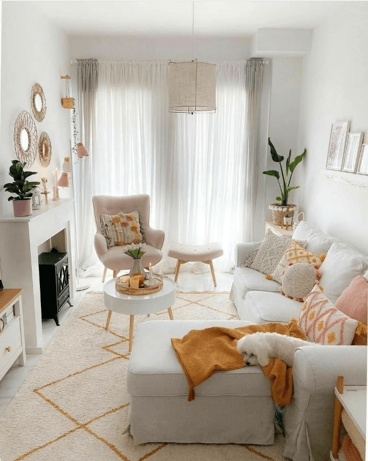 living room with accent chair, ottoman, and sofa with pillows