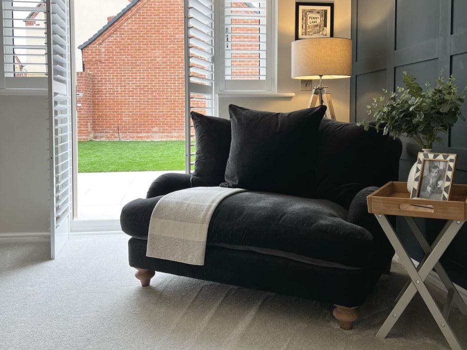 black loveseat with pillows